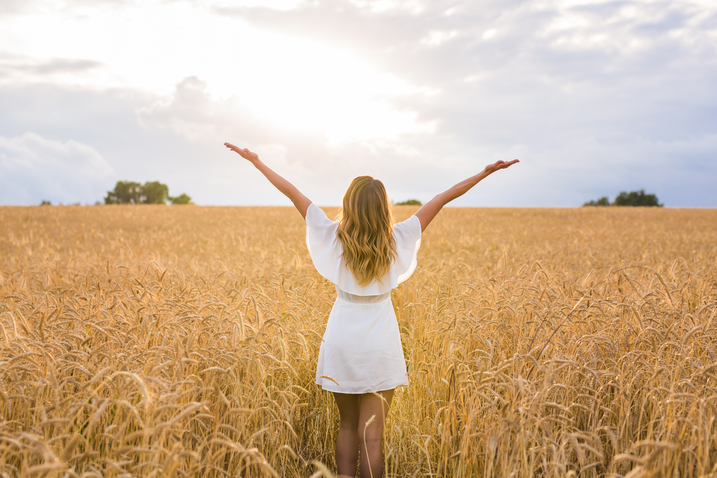 Happy Woman in Golden Wheat