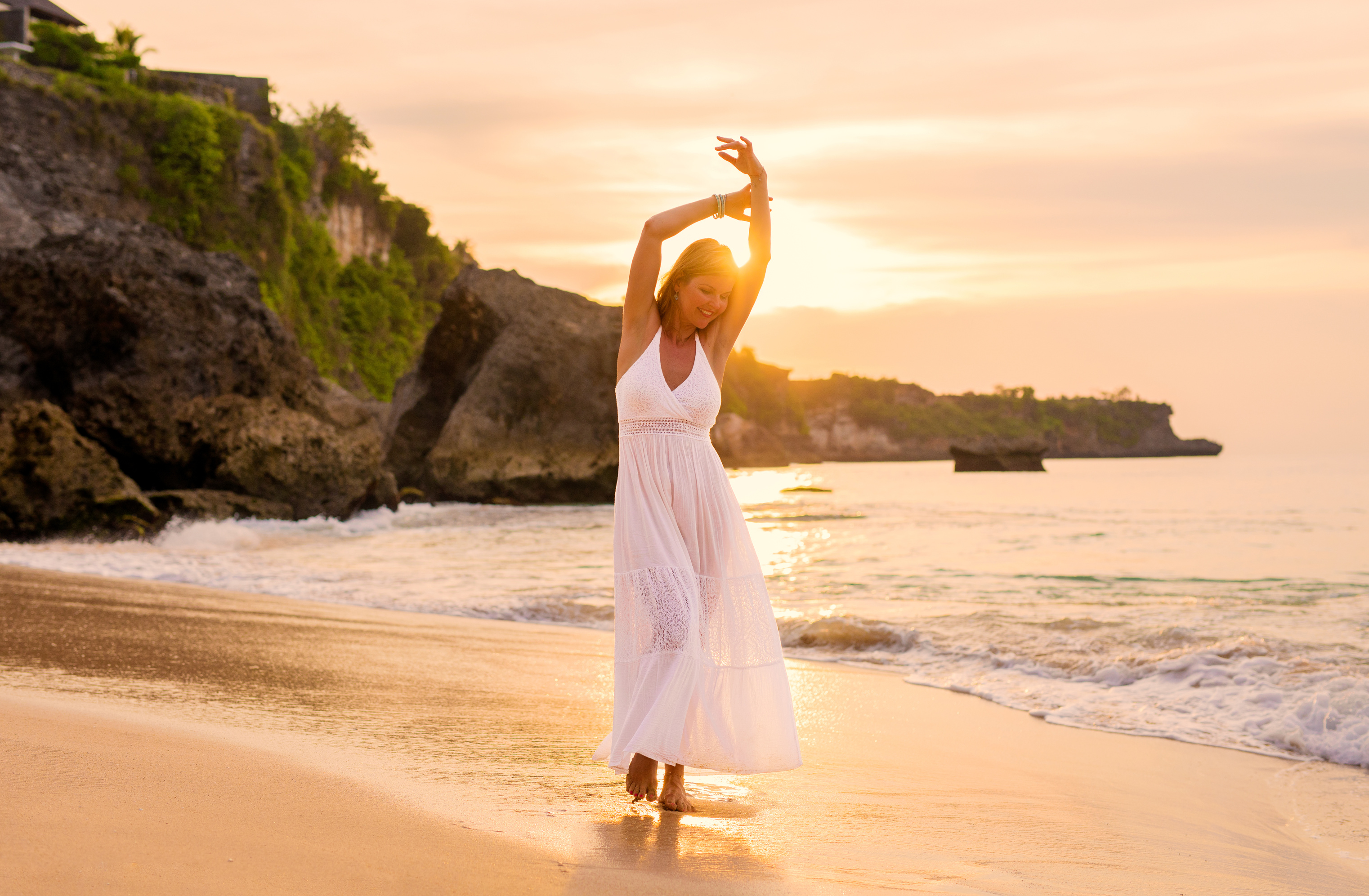 Happy Woman Walking on Beach at Sunset